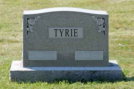 Tyrie gray granite upright monument with floral border.